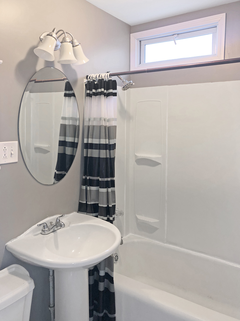 Undisclosed Address Round Lake Beach, IL 60073 - Photo 6 of 8 a bathroom with a sink a toilet and shower