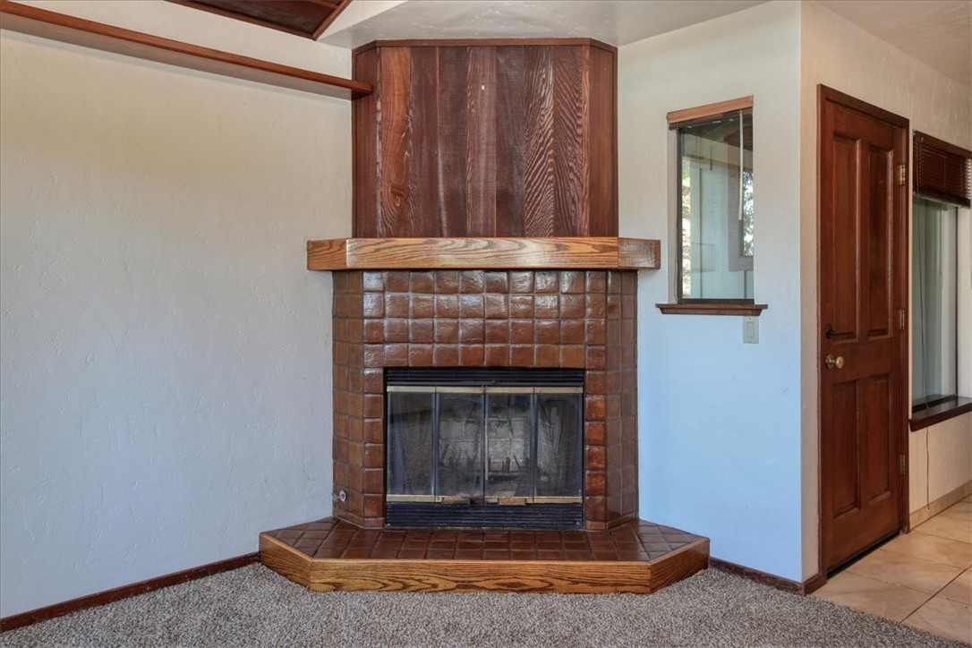 2550 Emerson Road Cambria, CA 93428 - Photo 16 of 49 a living room with a fireplace and a wooden floor