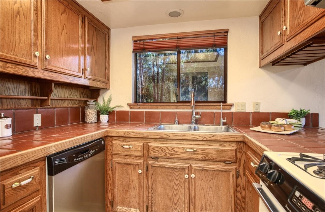 2550 Emerson Road Cambria, CA 93428 - Photo 20 of 49 a kitchen with stainless steel appliances granite countertop a sink stove and cabinets