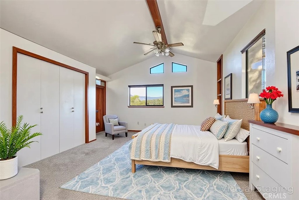 2550 Emerson Road Cambria, CA 93428 - Photo 30 of 49 a bedroom with a large bed and a chandelier