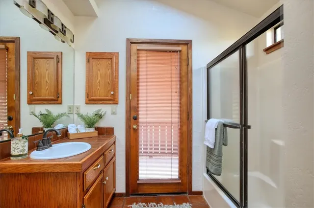 a balcony with wooden floor and fence