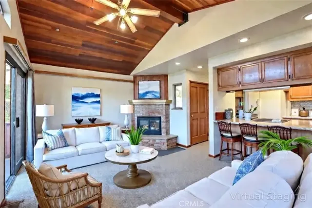 a living room with fireplace furniture and a large window