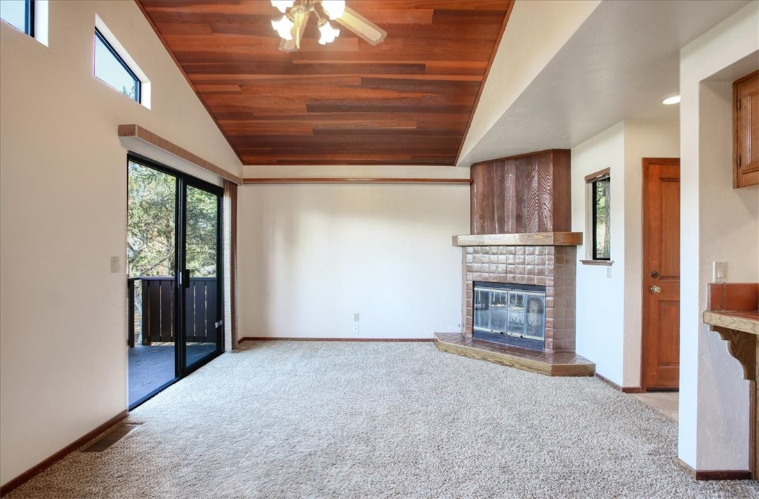 2550 Emerson Road Cambria, CA 93428 - Photo 7 of 49 an empty room with fireplace and windows