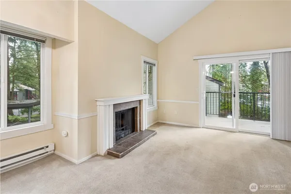 an empty room with furniture and a fireplace