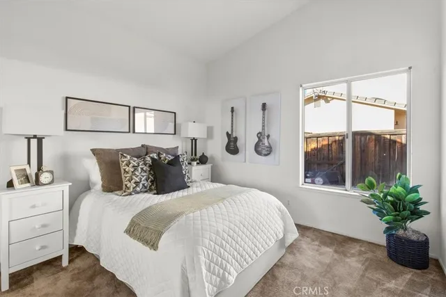 a bedroom with a large bed and a potted plant