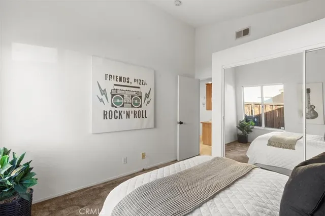 a bedroom with a bed and a potted plant