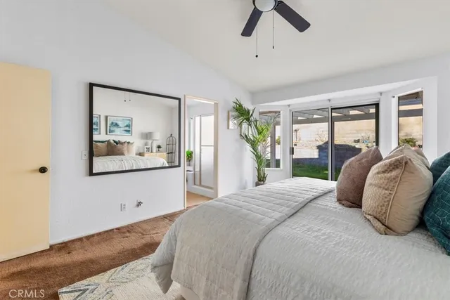 a bedroom with a large bed and a painting on the wall