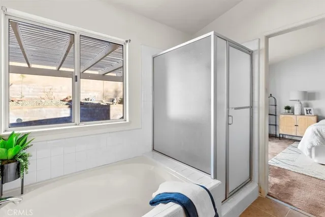 a bathroom with a bathtub and a shower