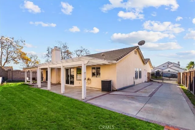 a view of a house with a yard and sitting area