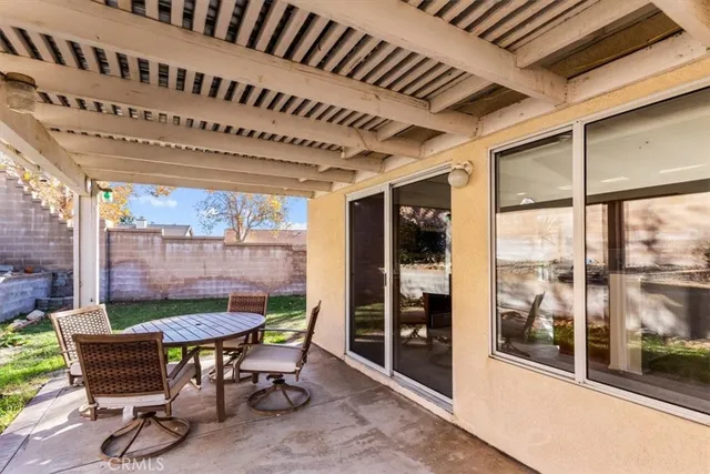 a view of a porch with chairs and backyard