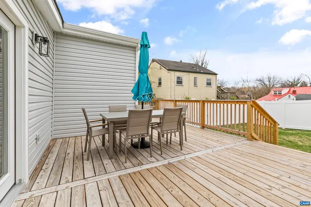 a large bed sitting in a bedroom next to a lamp with table and chair