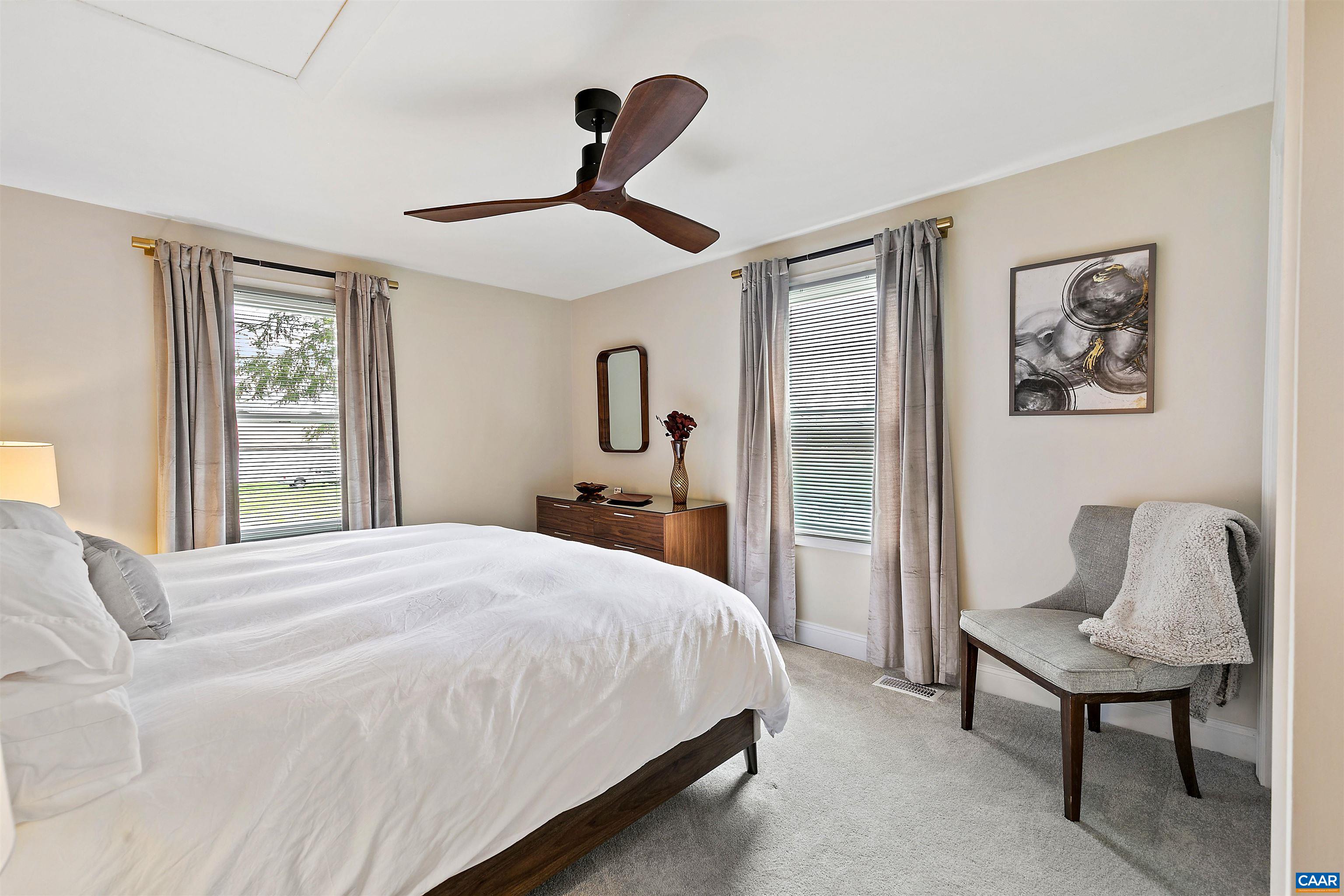 708 West Street Charlottesville, VA 22903 - Photo 25 of 34 a bedroom with a bed and a chandelier