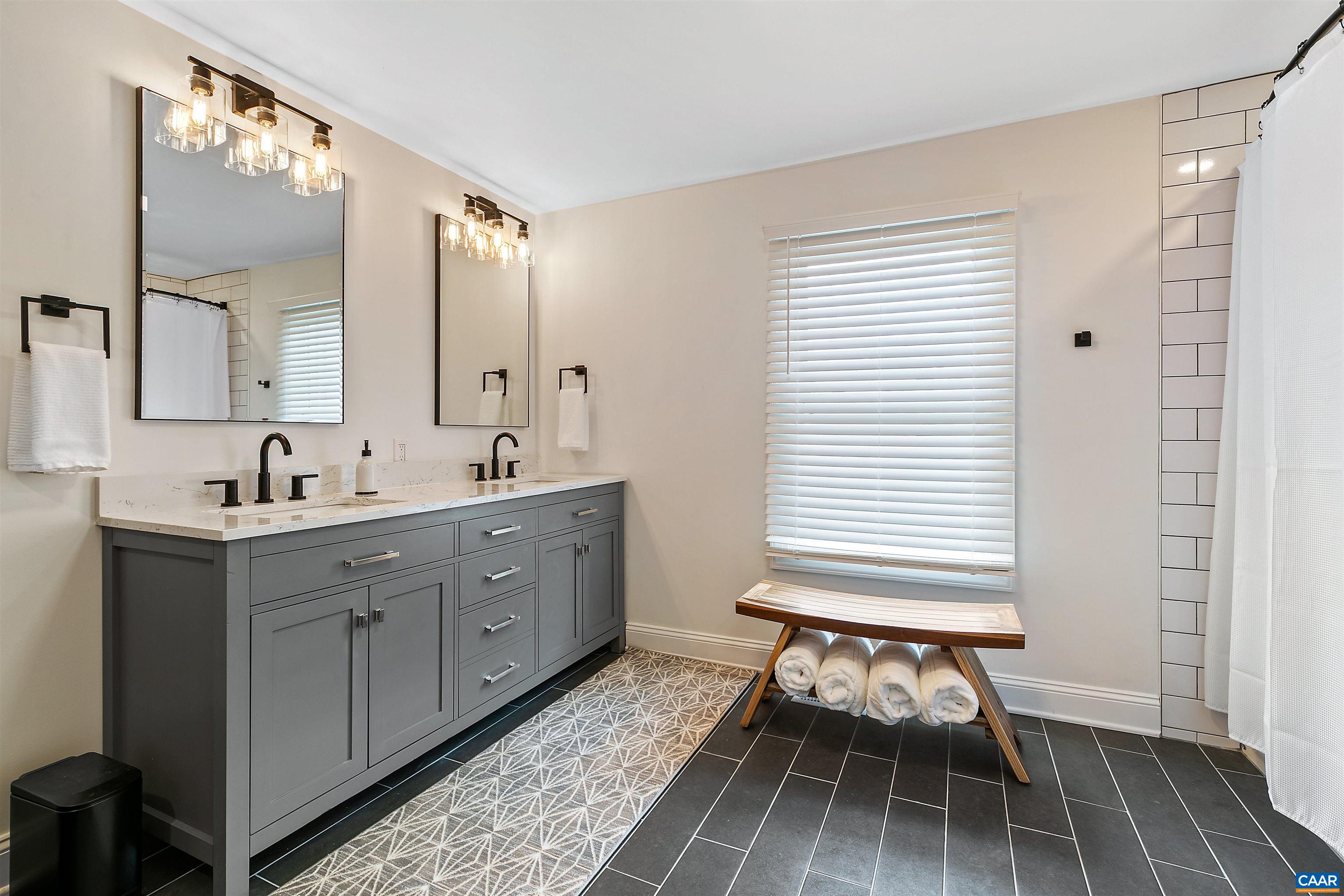 708 West Street Charlottesville, VA 22903 - Photo 29 of 34 a spacious bathroom with a double vanity sink mirror and a bathtub