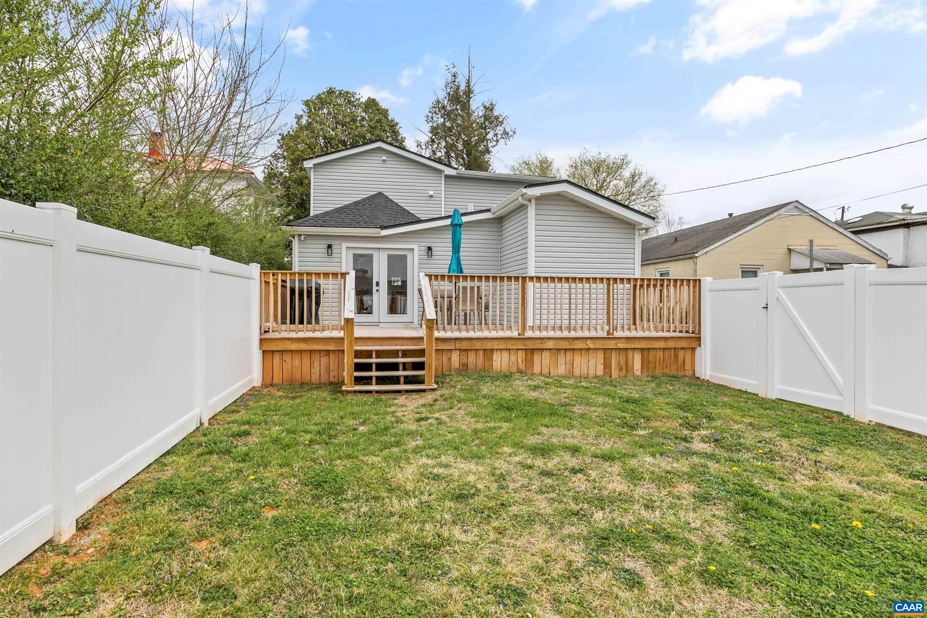 708 West Street Charlottesville, VA 22903 - Photo 34 of 34 a white house that has a small yard and wooden fence