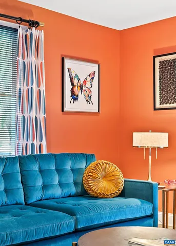 a kitchen with stainless steel appliances kitchen island granite countertop a refrigerator a sink a stove and white cabinets with wooden floor