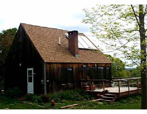 64 Brunelle Road Heath, MA 01340 - Photo 1 of 1 a view of house with backyard outdoor seating and covered with trees