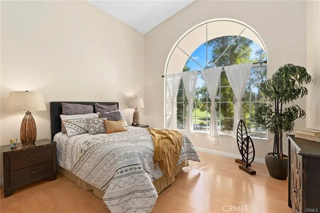 a bedroom with a bed and a painting on the wall