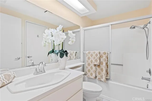 a bedroom with a bed lamp and a large window