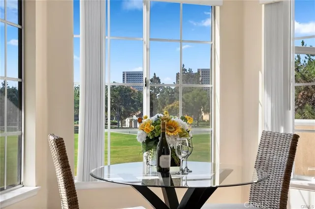 a spacious bedroom with a bed a couch and large windows