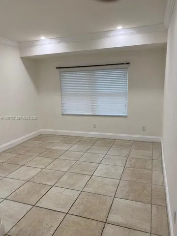 a view of a room with a wooden floor and cabinets