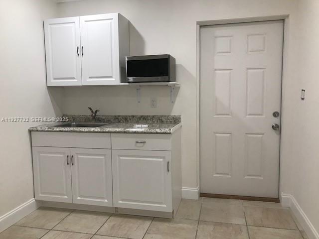 9420 Southwest 55th Street, Unit 2 Miami, FL 33165 - Photo 6 of 9 a kitchen with stainless steel appliances granite countertop white cabinets and sink
