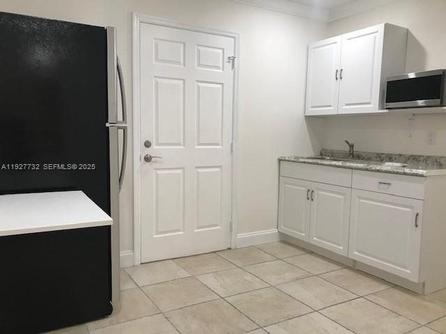 9420 Southwest 55th Street, Unit 2 Miami, FL 33165 - Photo 7 of 9 a kitchen with a sink and cabinets