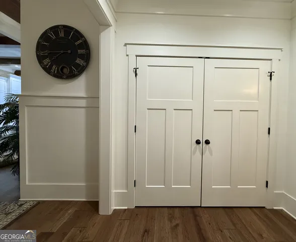 a large kitchen with a lot of cabinets and a wooden floor