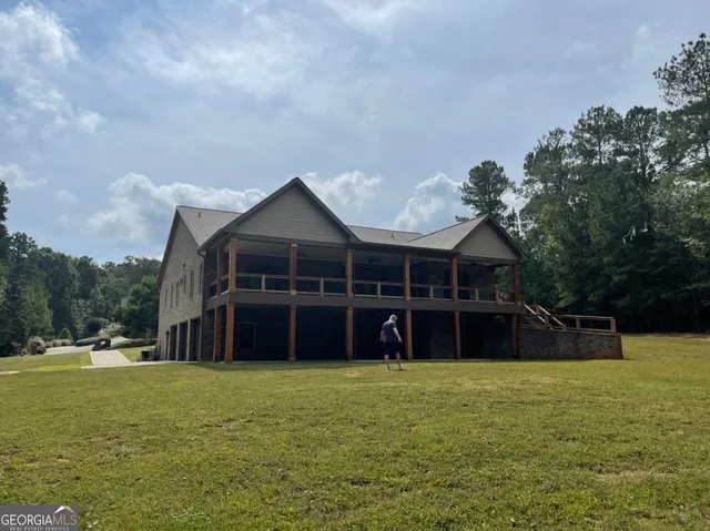 a living room with a fireplace and a ceiling fan