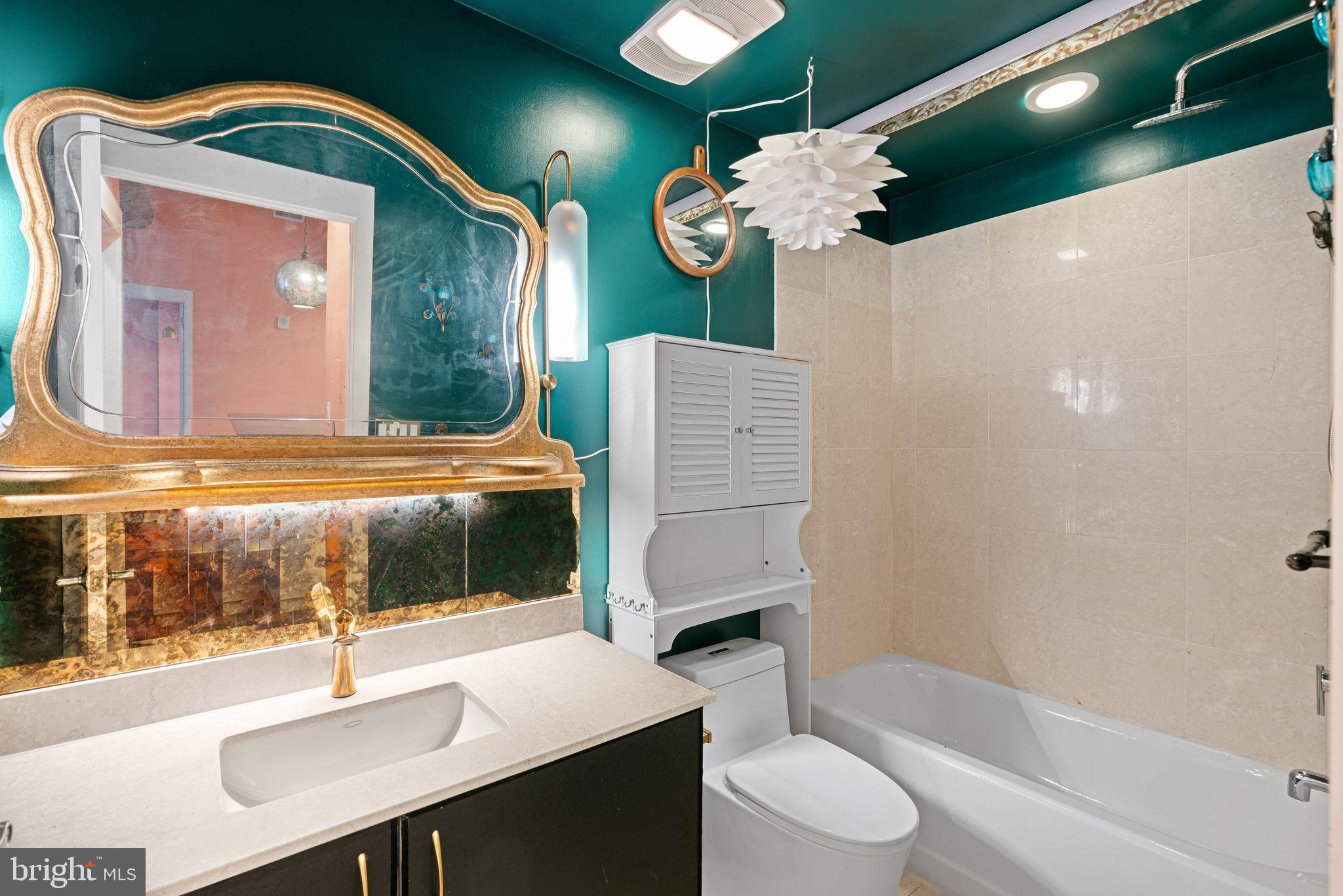 1101 Locust Street, Unit 4L Philadelphia, PA 19107 - Photo 15 of 25 a bathroom with a sink a toilet and a mirror