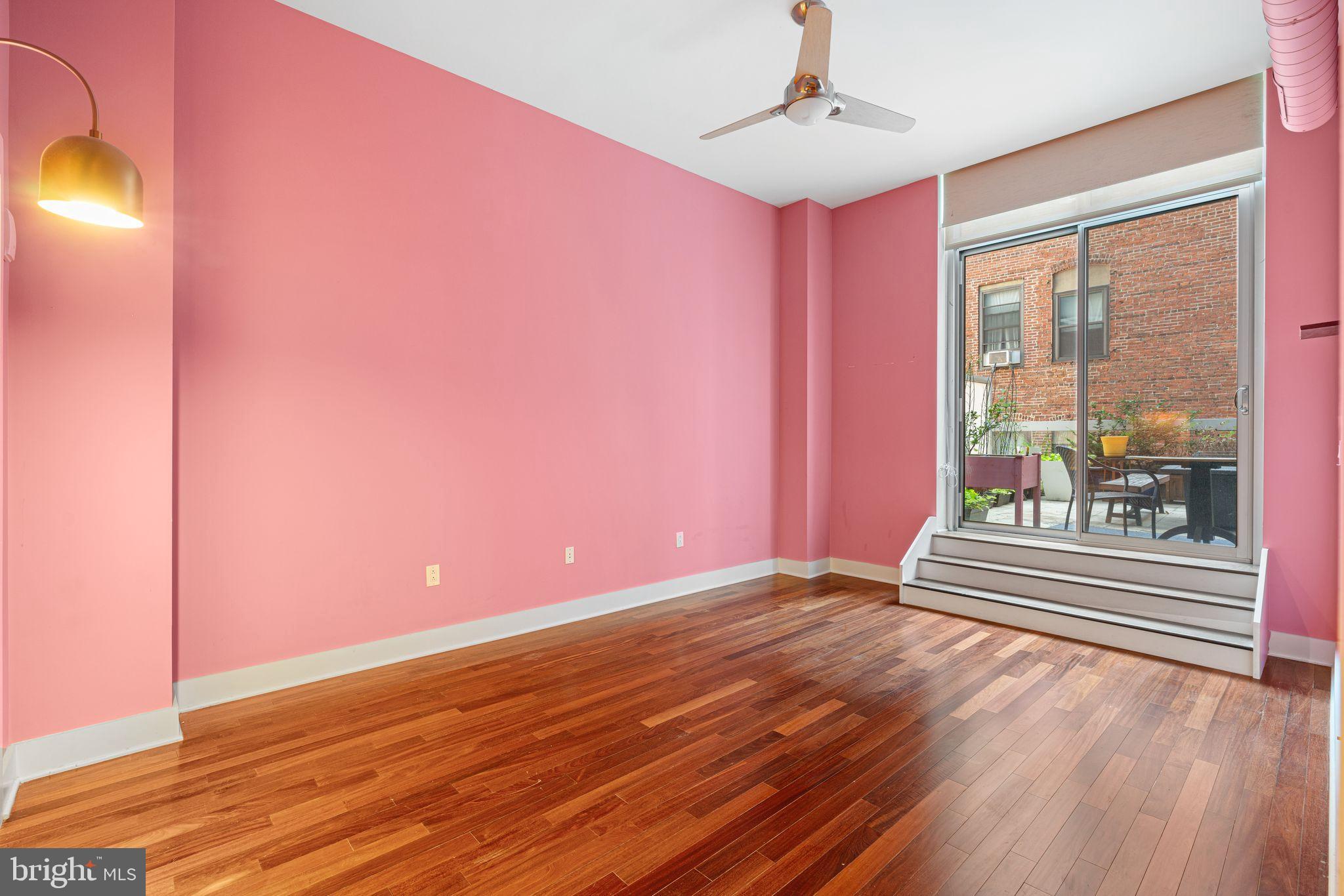 1101 Locust Street, Unit 4L Philadelphia, PA 19107 - Photo 16 of 25 a view of a room with wooden floor and a floor to ceiling window