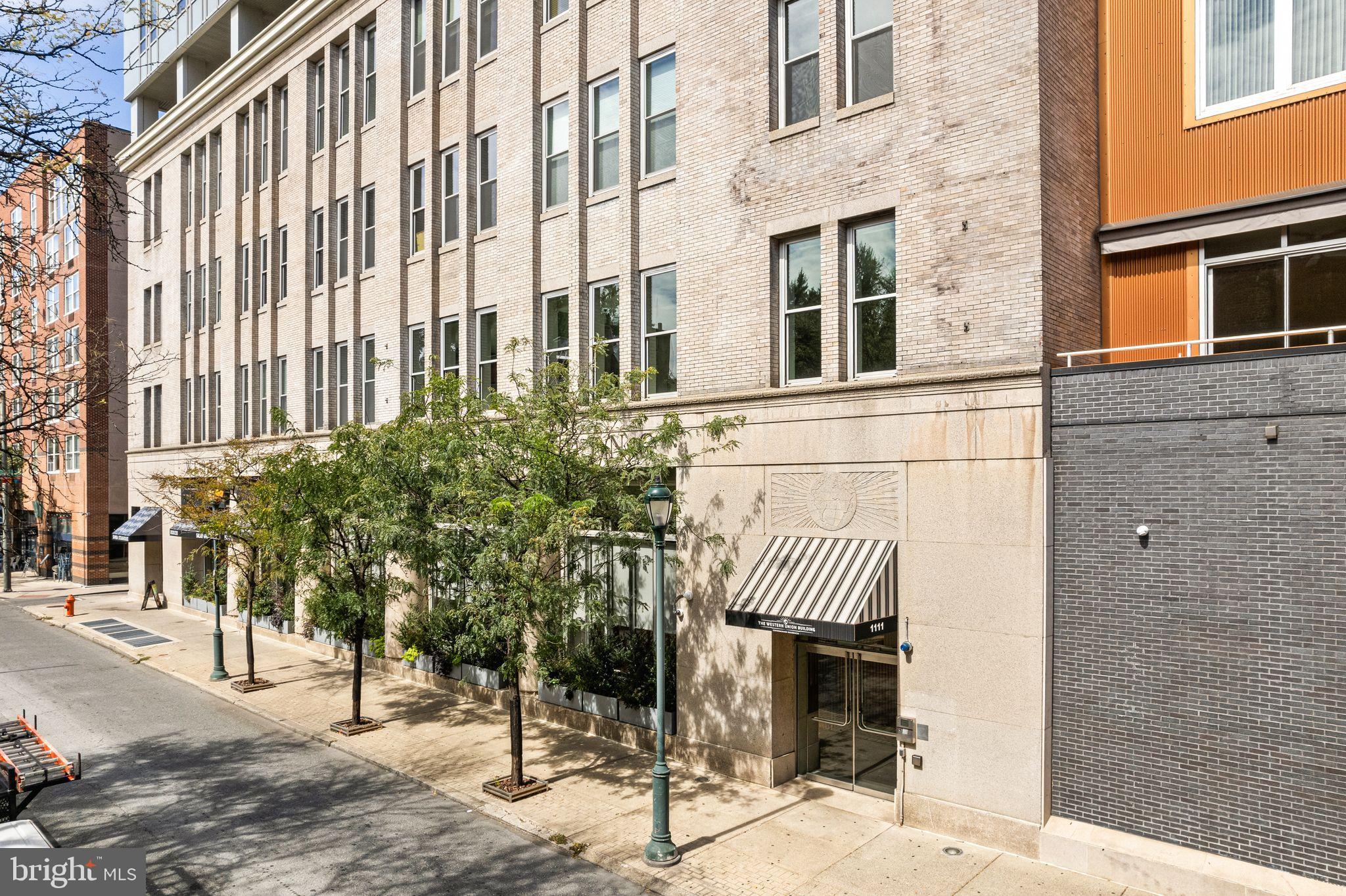 1101 Locust Street, Unit 4L Philadelphia, PA 19107 - Photo 23 of 25 a view of a brick house with many windows