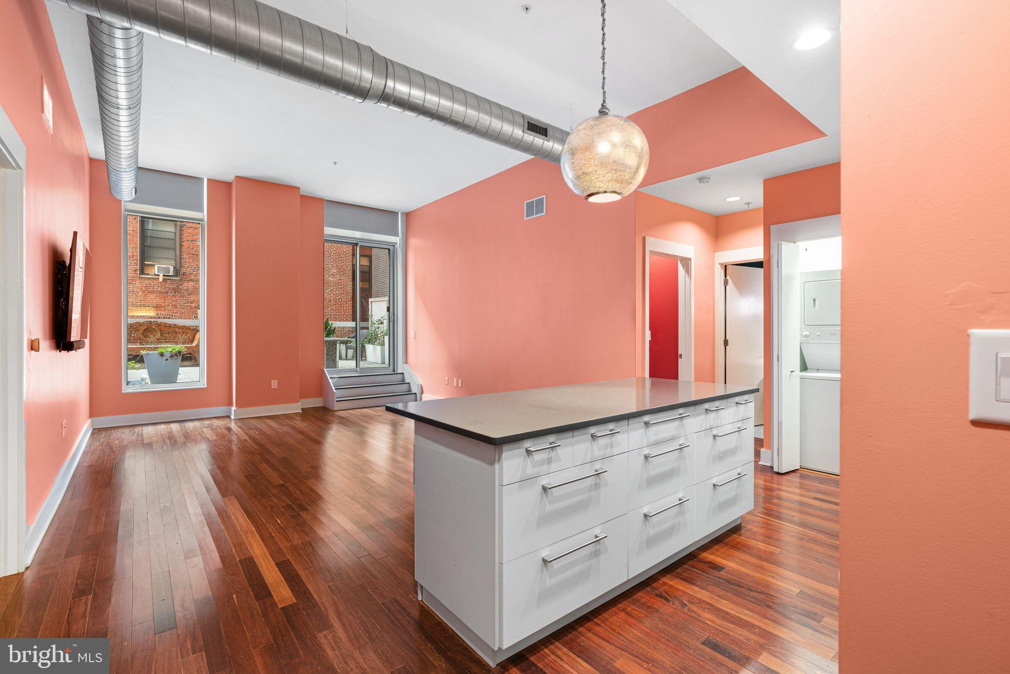 1101 Locust Street, Unit 4L Philadelphia, PA 19107 - Photo 4 of 25 a kitchen with granite countertop a stove and a wooden floor