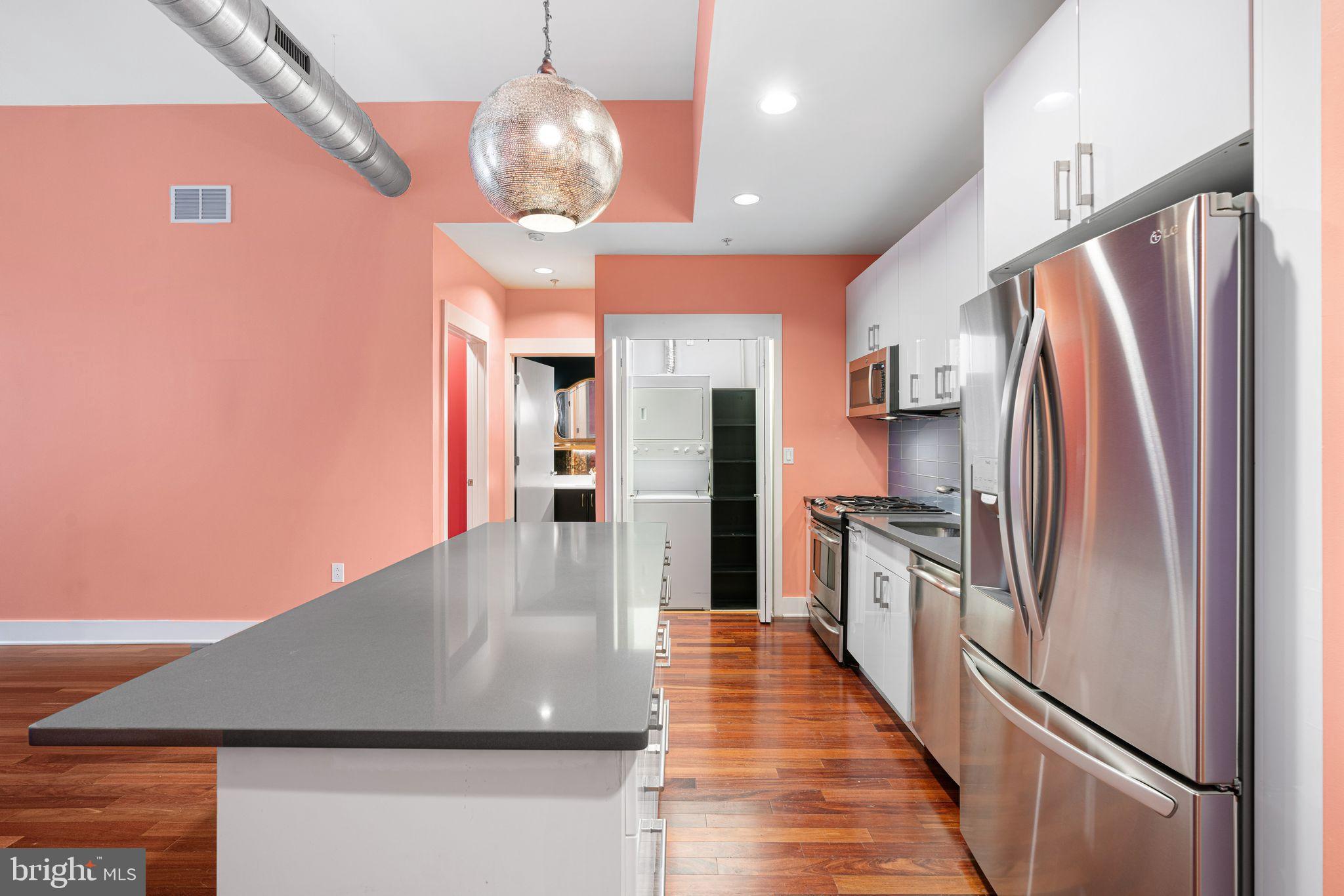1101 Locust Street, Unit 4L Philadelphia, PA 19107 - Photo 5 of 25 a kitchen with stainless steel appliances granite countertop a refrigerator a oven and a stove