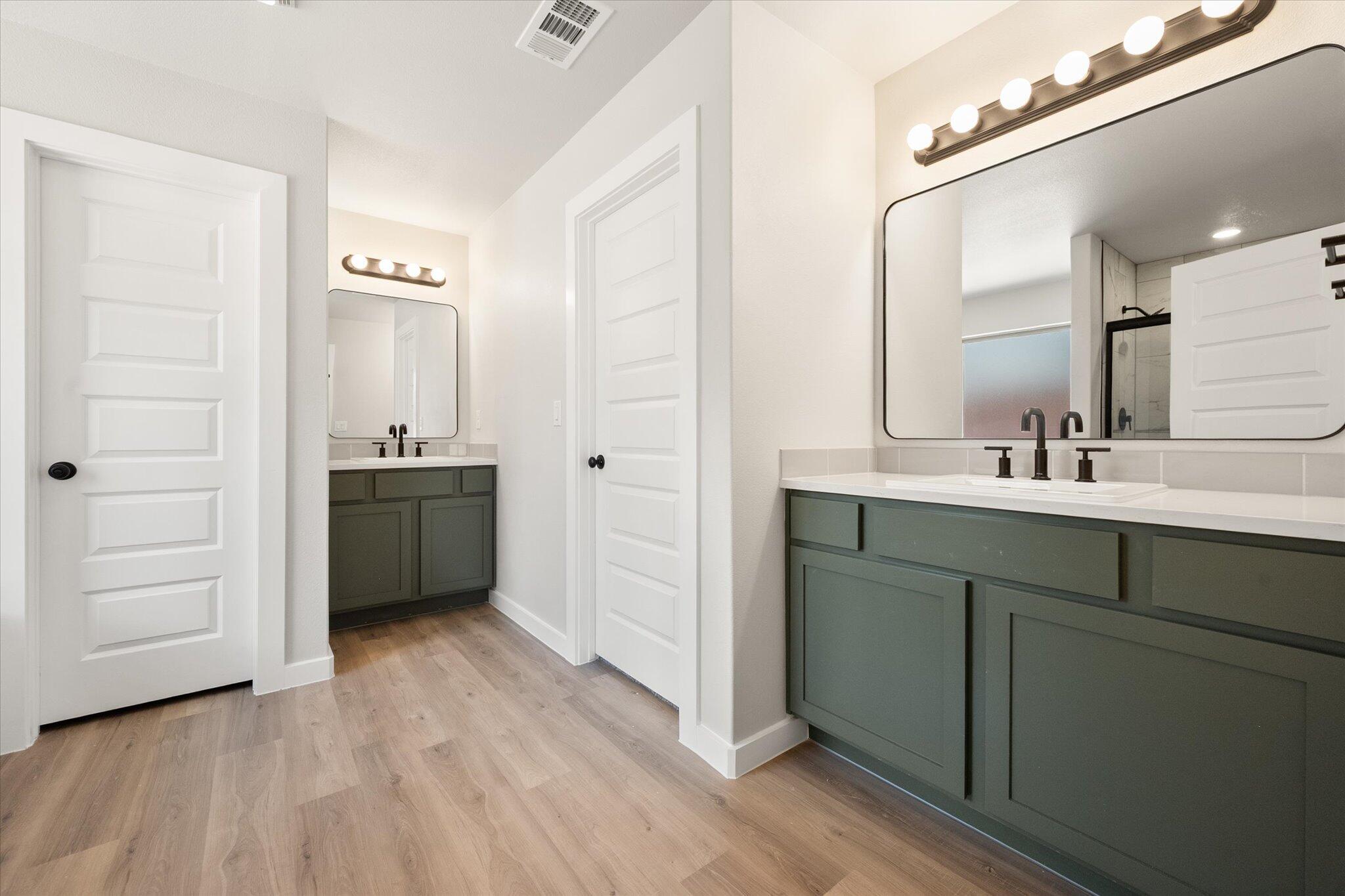 7436 29th Street Lubbock, TX 79407 - Photo 14 of 22 a bathroom with a sink a mirror and a shower