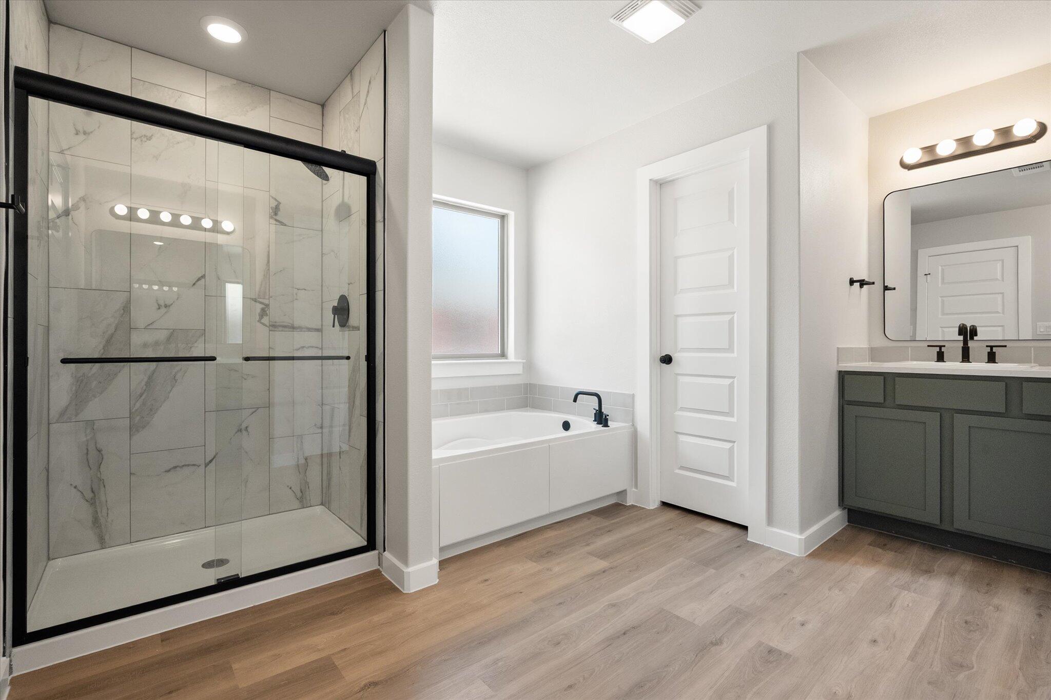 7436 29th Street Lubbock, TX 79407 - Photo 15 of 22 a bathroom with a bathtub and a shower