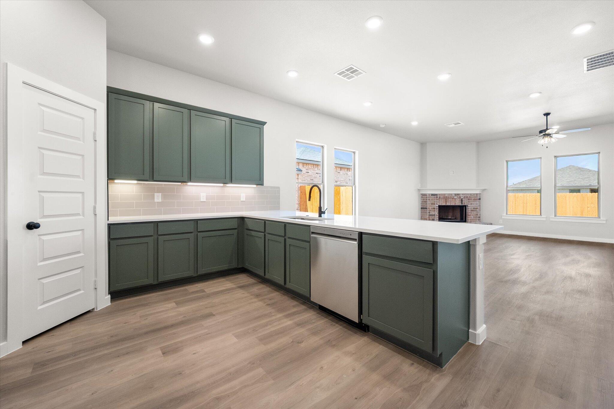 7436 29th Street Lubbock, TX 79407 - Photo 3 of 22 a kitchen with stainless steel appliances kitchen island granite countertop a sink and cabinets