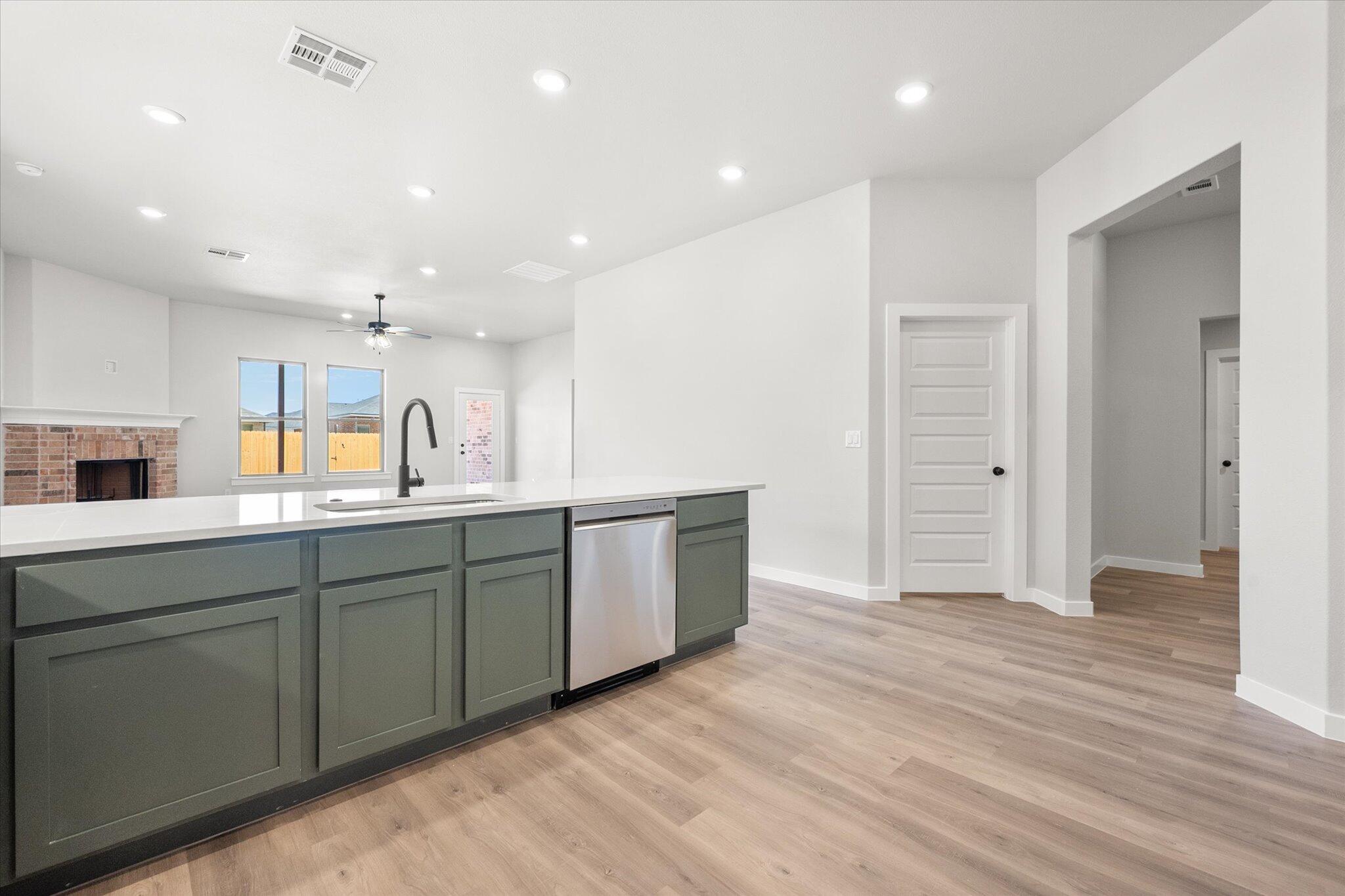 7436 29th Street Lubbock, TX 79407 - Photo 7 of 22 a large kitchen with stainless steel appliances granite countertop a large counter top and a wooden floors
