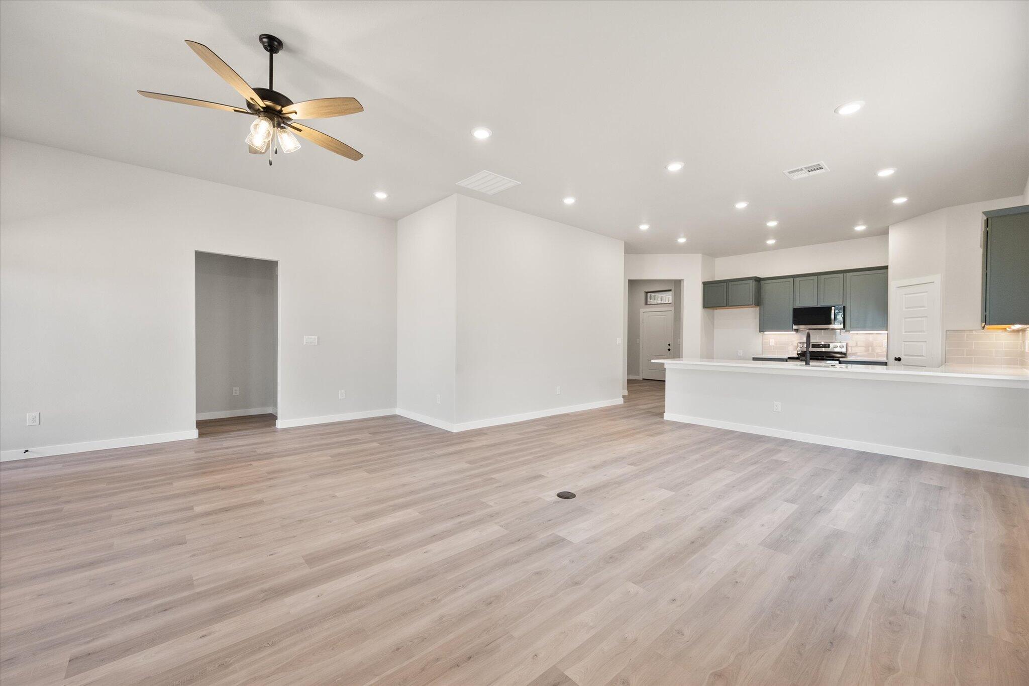 7436 29th Street Lubbock, TX 79407 - Photo 10 of 22 a view of kitchen and kitchen with a sink wooden floor