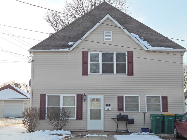 109 South Stott Street, Unit 2 Genoa, IL 60135 - Photo 1 of 14 a front view of a house with a yard