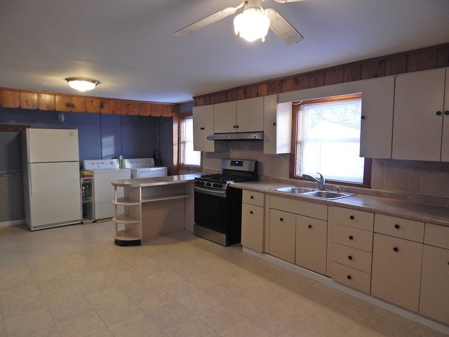 109 South Stott Street, Unit 2 Genoa, IL 60135 - Photo 3 of 14 a kitchen with a refrigerator sink and cabinets