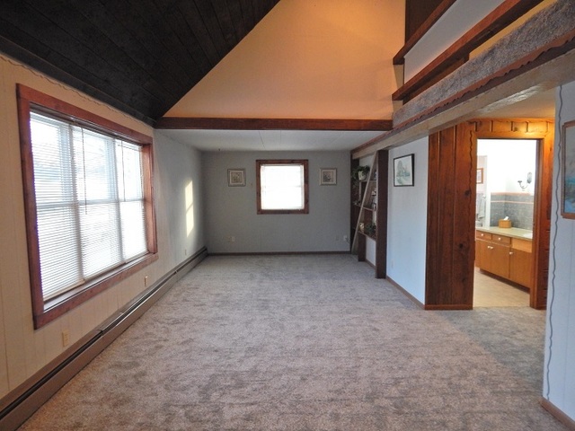 109 South Stott Street, Unit 2 Genoa, IL 60135 - Photo 5 of 14 a view of empty room with windows