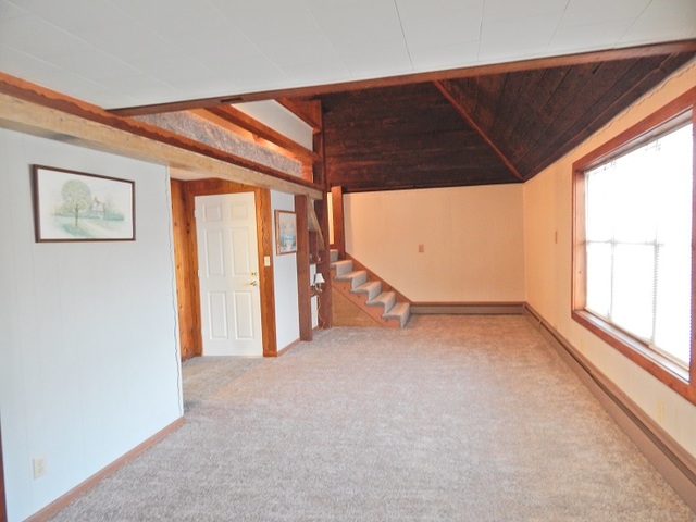 109 South Stott Street, Unit 2 Genoa, IL 60135 - Photo 6 of 14 an empty room with windows