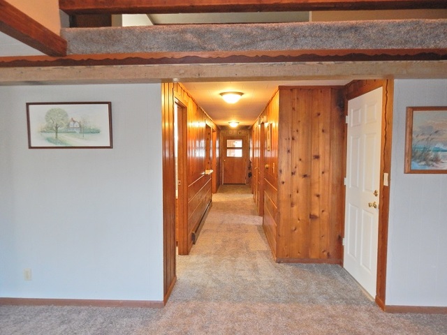 109 South Stott Street, Unit 2 Genoa, IL 60135 - Photo 7 of 14 a view of a hallway with wooden shelves