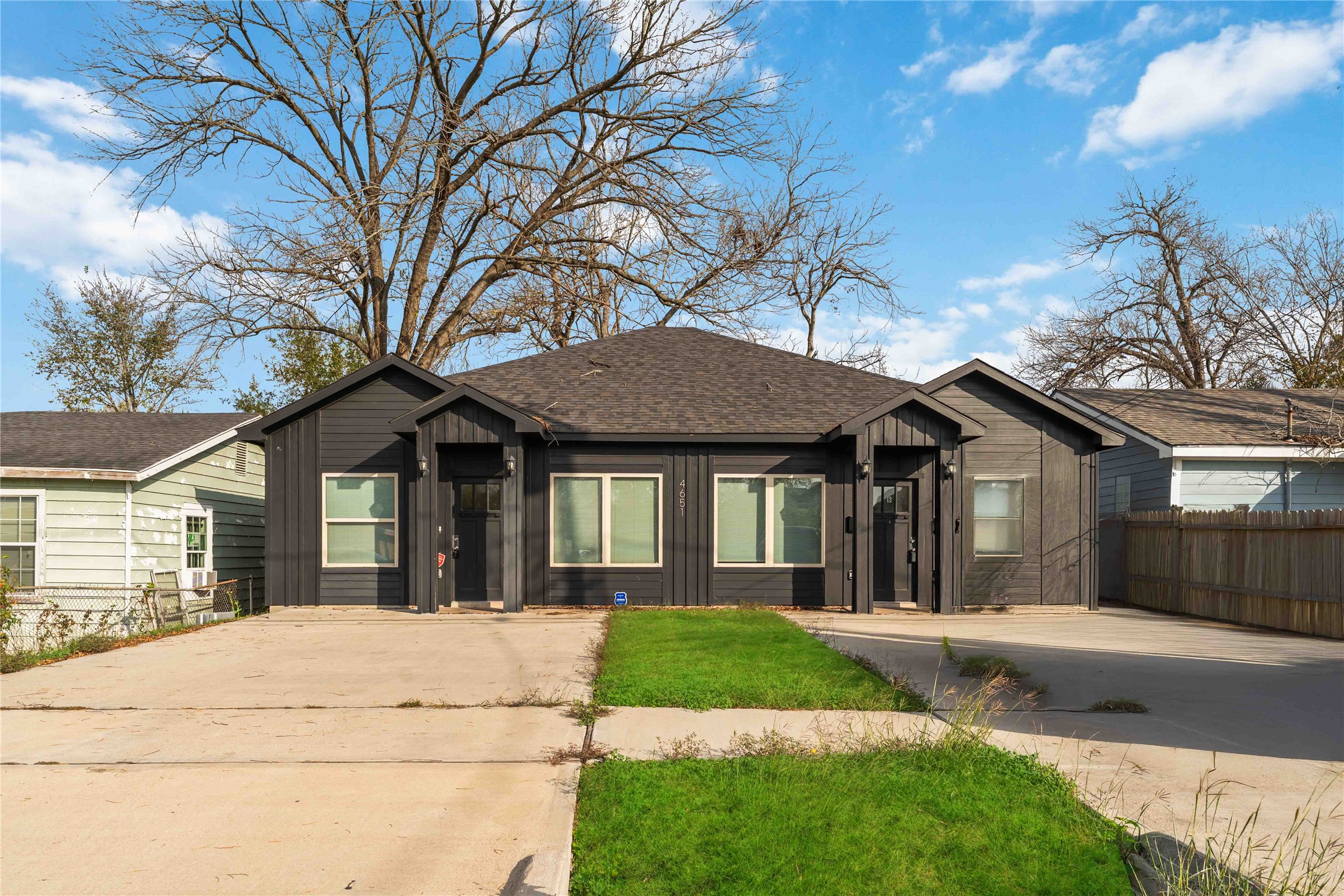 a front view of a house with a garden and yard