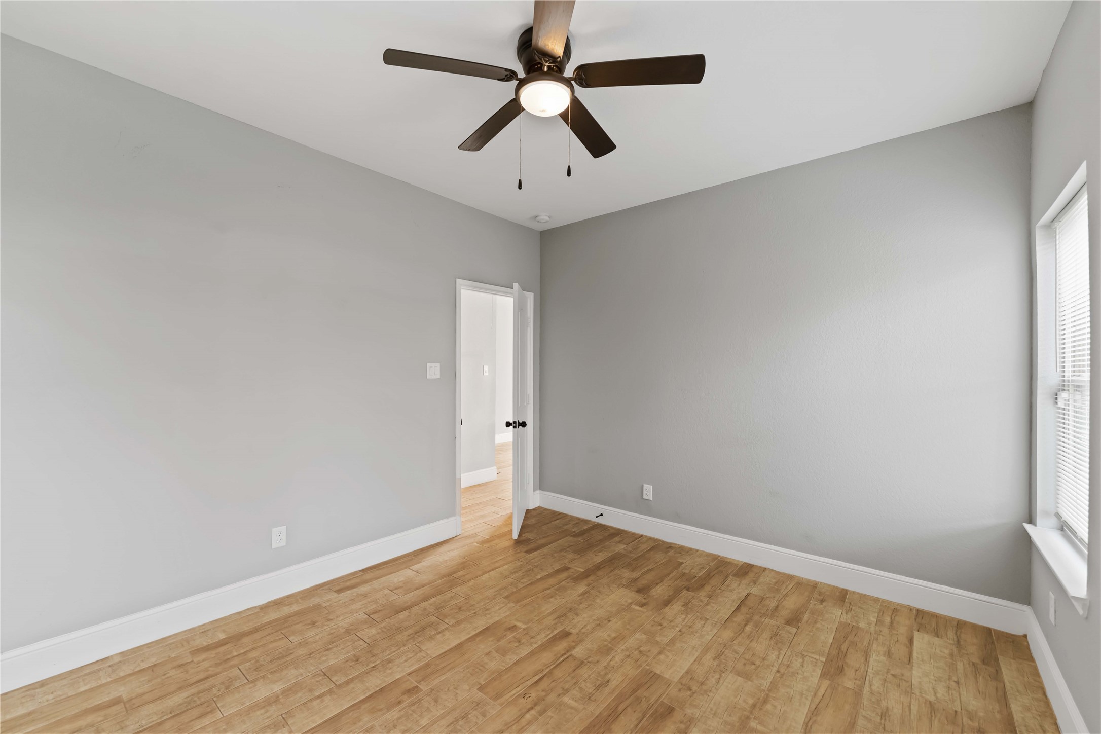 4651 Mallow Street, Unit AB Houston, TX 77051 - Photo 15 of 20 an empty room with a window and a ceiling fan