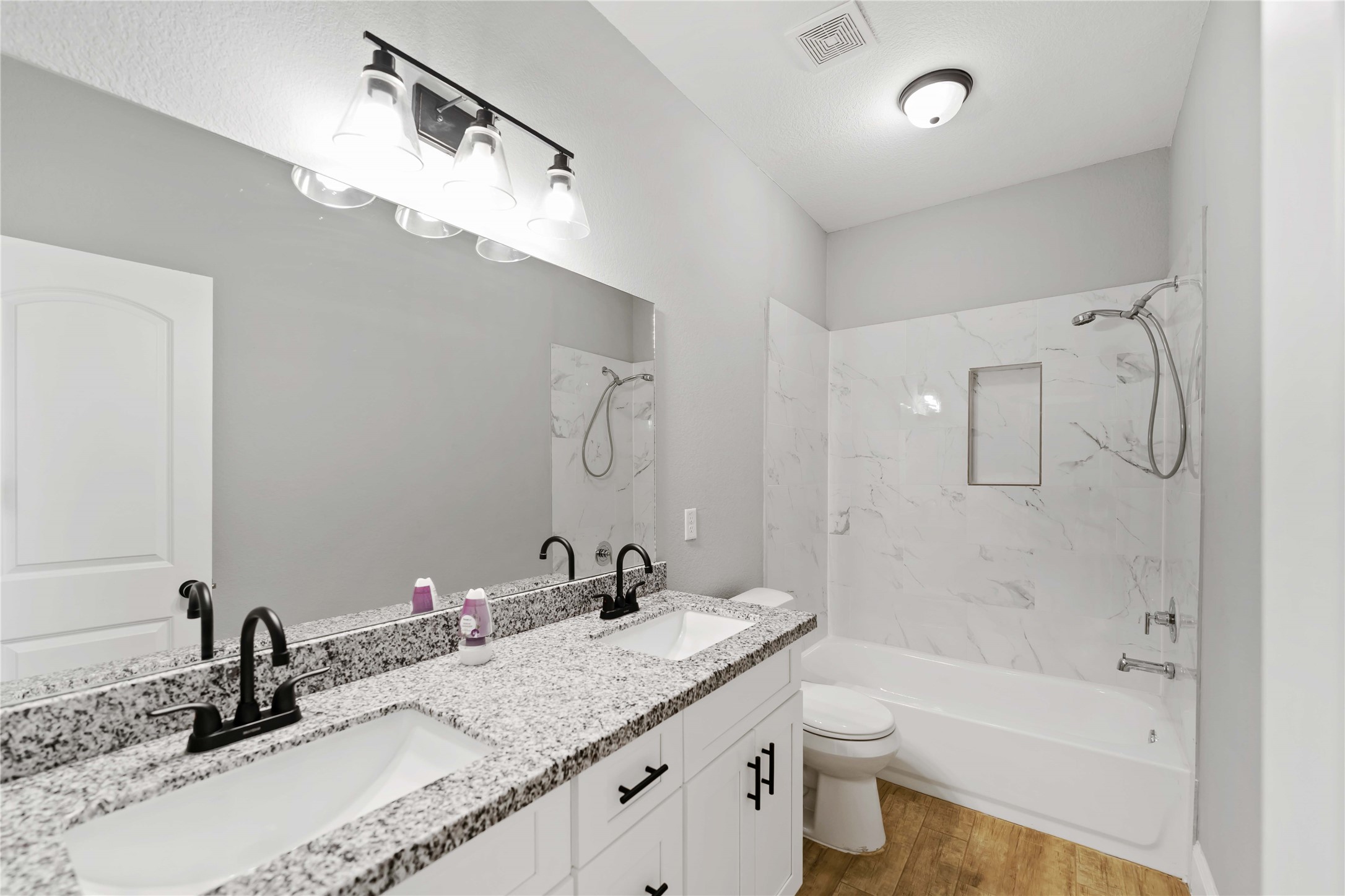 4651 Mallow Street, Unit AB Houston, TX 77051 - Photo 16 of 20 a bathroom with a granite countertop sink a toilet and shower