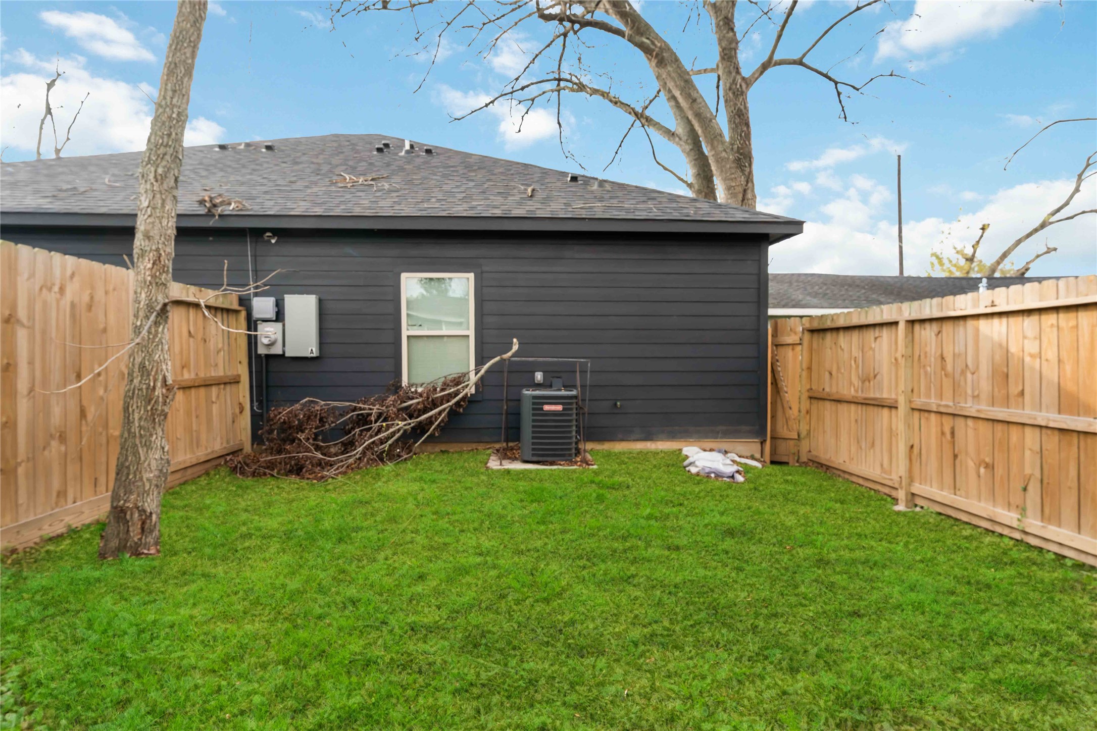4651 Mallow Street, Unit AB Houston, TX 77051 - Photo 20 of 20 a view of a backyard with table and chairs and a large tree