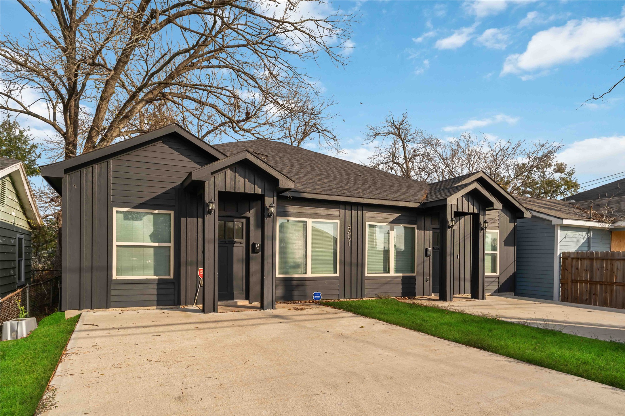 4651 Mallow Street, Unit AB Houston, TX 77051 - Photo 3 of 20 a front view of a house with a garden and trees