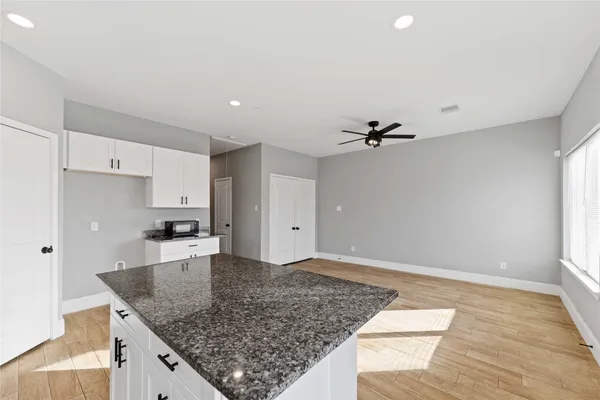 a kitchen with a sink refrigerator and microwave