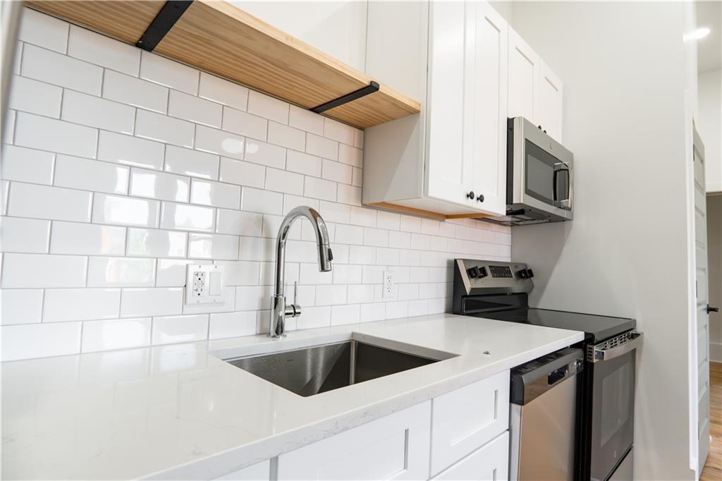 4402 Butler Street Pittsburgh, PA 15201 - Photo 13 of 28 a view of a kitchen with a sink and cabinets